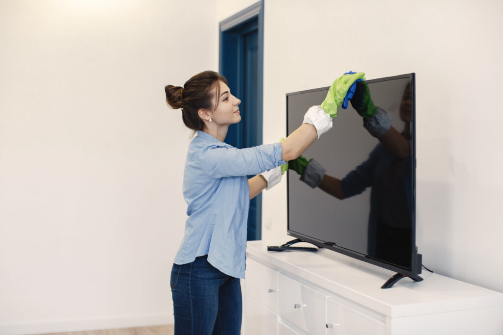 Woman clean TV.